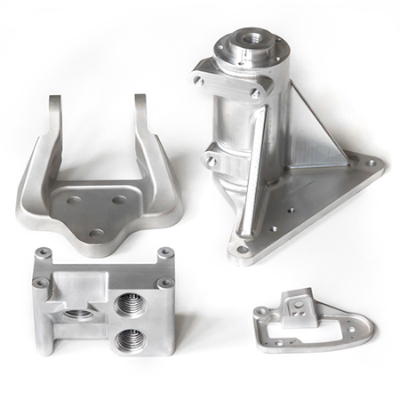 four precision engineering machined parts by Universal Fabrications (Coventry) Ltd