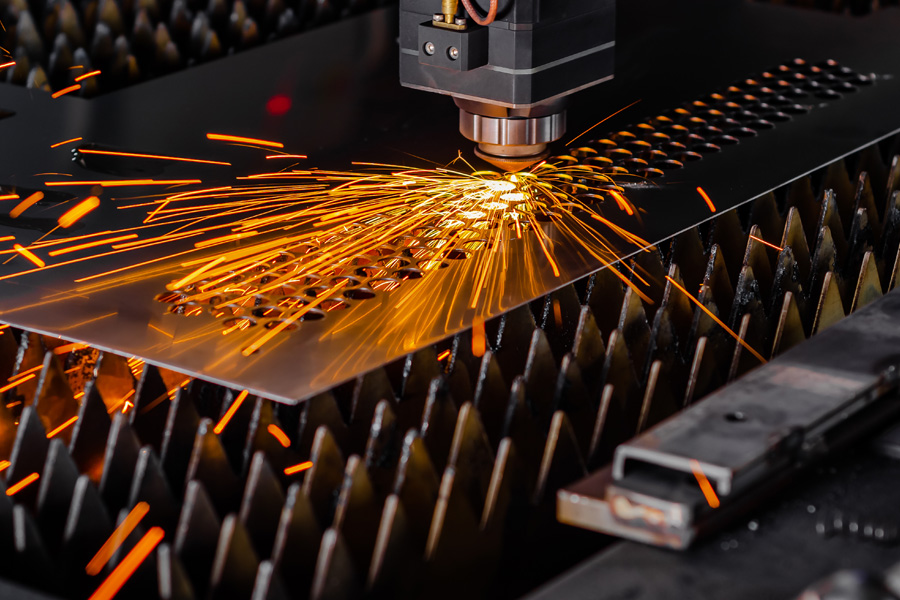 laser cutting machine cutting a metal sheet with sparks flying 