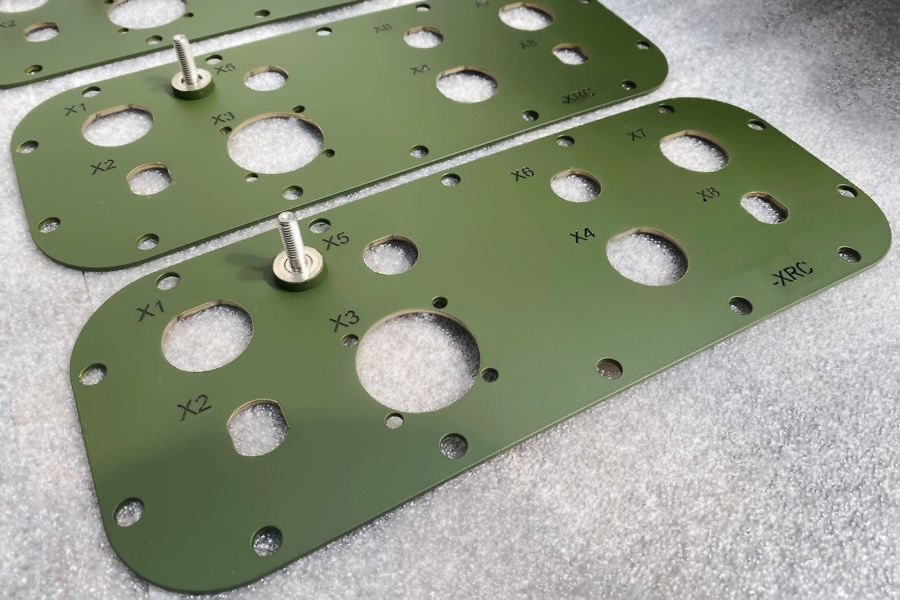 laser cut metal parts painted green manufactured by metal fabrication company in Coventry