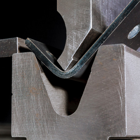 close up metal bending machine bending metal at manufacturing company