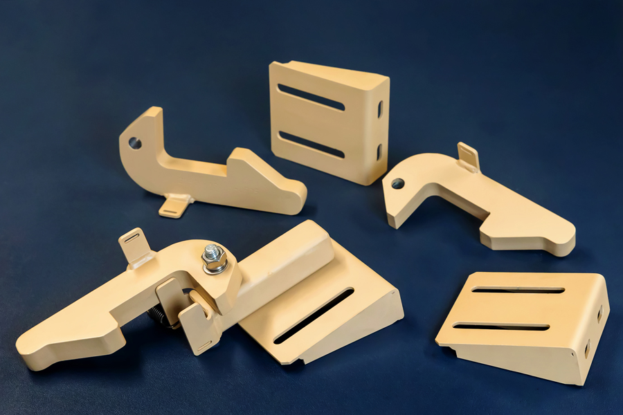 five production welded parts in desert tan manufactured by UK metal fabricators