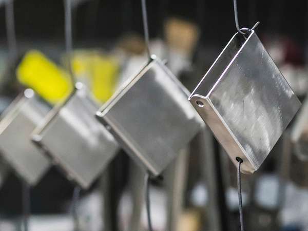 metal parts awaiting paint treatment representing Universal Fabrications finishing and coating service