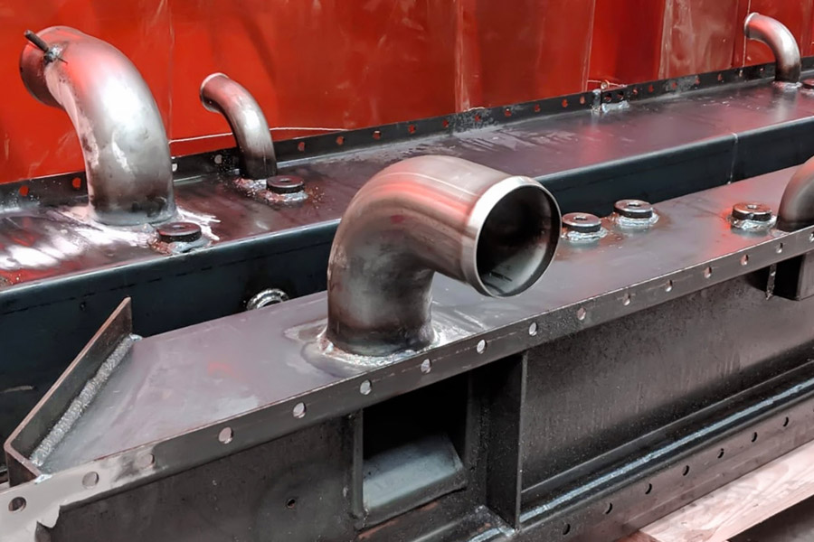 Welded structural fabrication showing machined interface areas for tolerance control